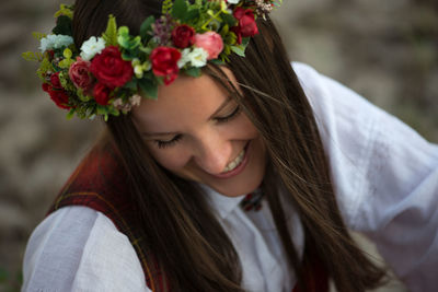 High angle view of smiling beautiful woman wearing flowers wreath