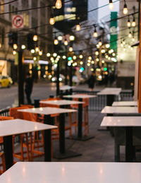 Empty chairs and table in cafe at night