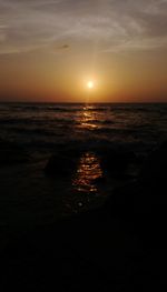 Scenic view of sea against sky at sunset