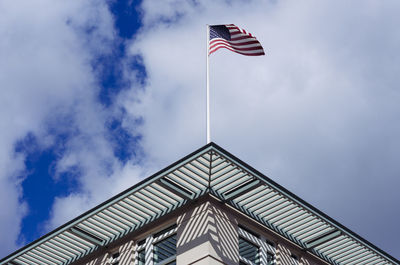 Low angle view of american flag against cloudy sky