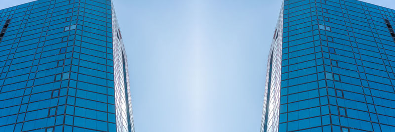 Low angle view of modern building against clear blue sky