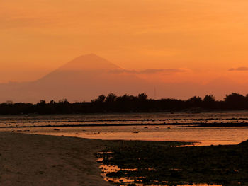 Scenic view of silhouette land against sky during sunset