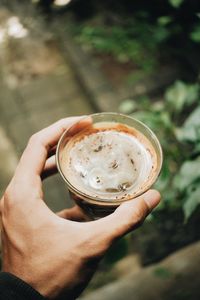 Cropped hand holding coffee