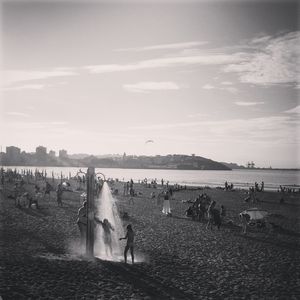 Woman standing by sea against sky