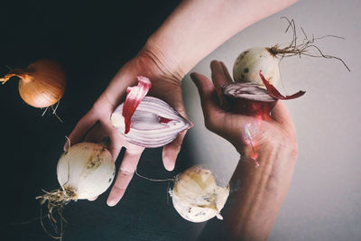 Double exposure of hand holding onions