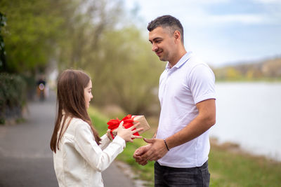 Side view of young woman holding bouquet