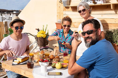 People at family enjoying breakfast in balcony