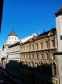 Low angle view of building against clear blue sky