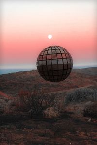 Built structure on land against sky during sunset