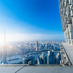 Modern buildings in city against blue sky