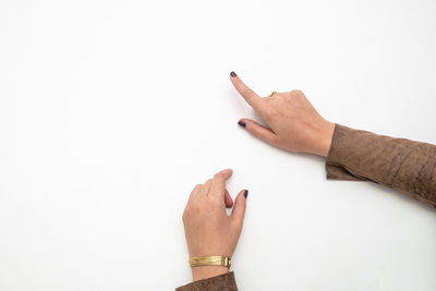 Close-up of woman hand against white background