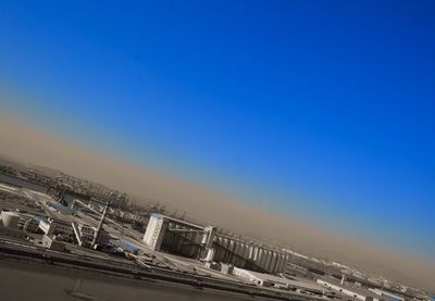 Cars on road against clear blue sky