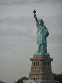 Low angle view of statue against cloudy sky