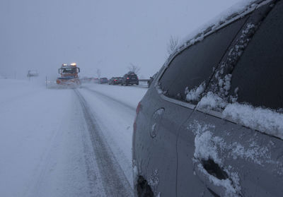 Snow plow on a country road, traffic and mobility in winter