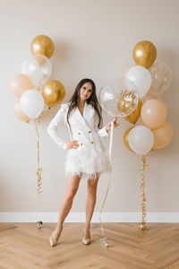 Young caucasian woman holding a balloon in her hands in honor of her thirtieth birthday person