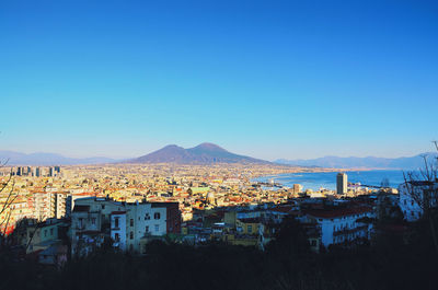 High angle view of townscape against clear blue sky