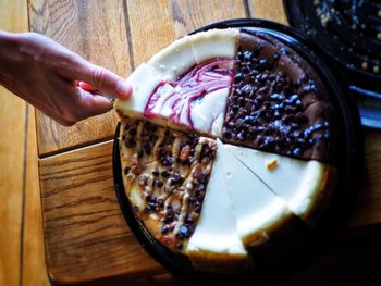 Midsection of person holding ice cream on table