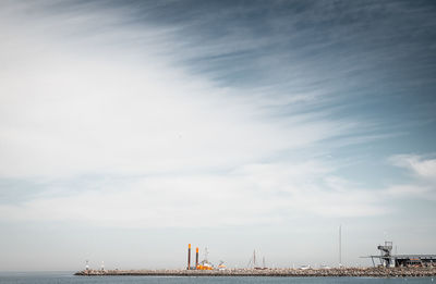 Harbor by sea against sky