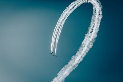 Low angle view of airplane flying against sky