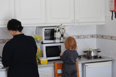 Mother and daughter at kitchen counter