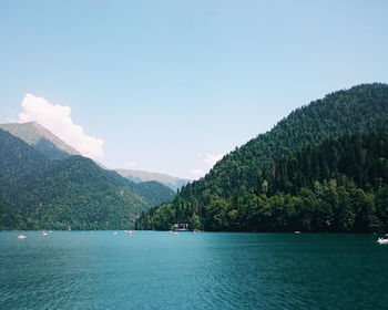 Scenic view of sea and mountains against sky