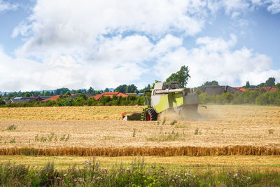 Traditional windmill on field against sky