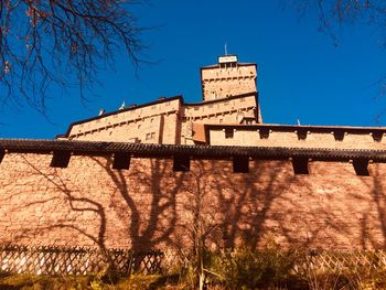 Low angle view of building against blue sky