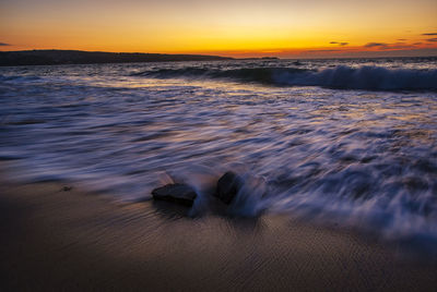 Scenic view of sea against sky during sunset