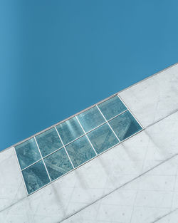 Low angle view of modern building against clear blue sky