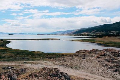 Scenic view of lake against cloudy sky