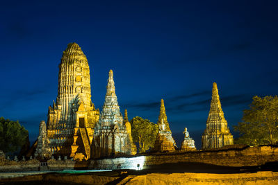 Temple by building against sky in city