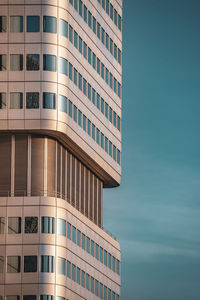 Low angle view of modern building against blue sky