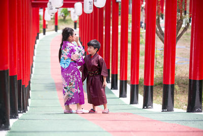 Full length of women walking on footpath