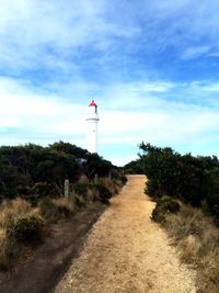 Lighthouse against cloudy sky