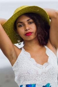 Portrait of beautiful young woman standing at beach