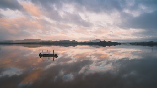 Scenic view of lake against sky during sunset