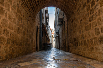 Narrow alley amidst buildings in city