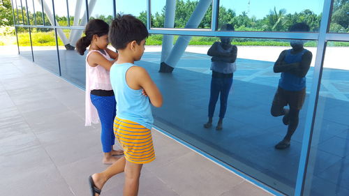 Rear view of women standing in swimming pool