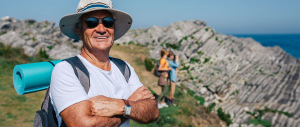 Portrait of man wearing sunglasses standing outdoors