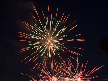 Low angle view of firework display at night