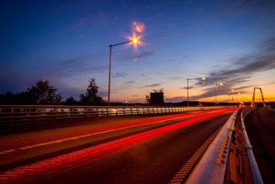 Light trails on road at dusk