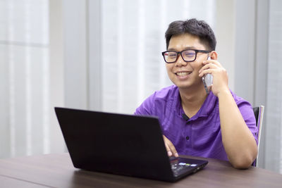 Mid adult man using mobile phone