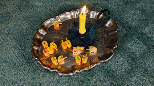 High angle view of burning candle