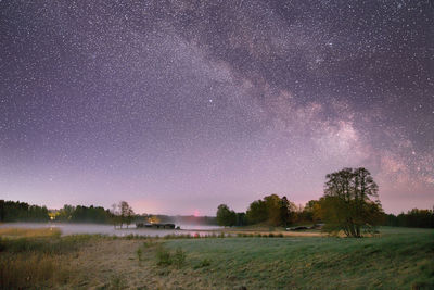 Scenic view of field against sky at night