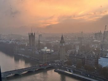 High angle view of buildings in city during sunset