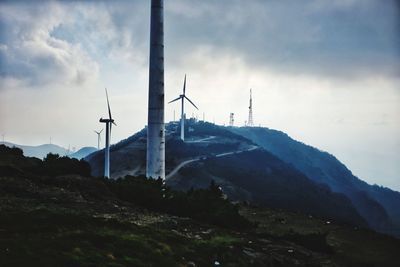 Windmill on mountain against sky