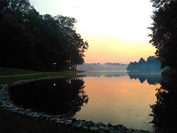 Scenic view of calm lake at sunset