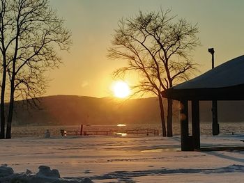 Scenic view of frozen lake against sky during sunset