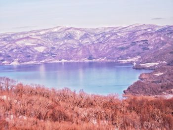 Scenic view of lake and mountains against sky