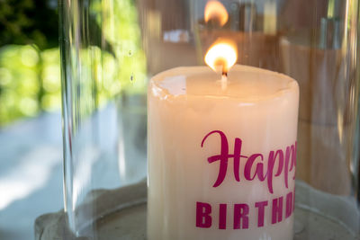 Close-up of illuminated candles on table